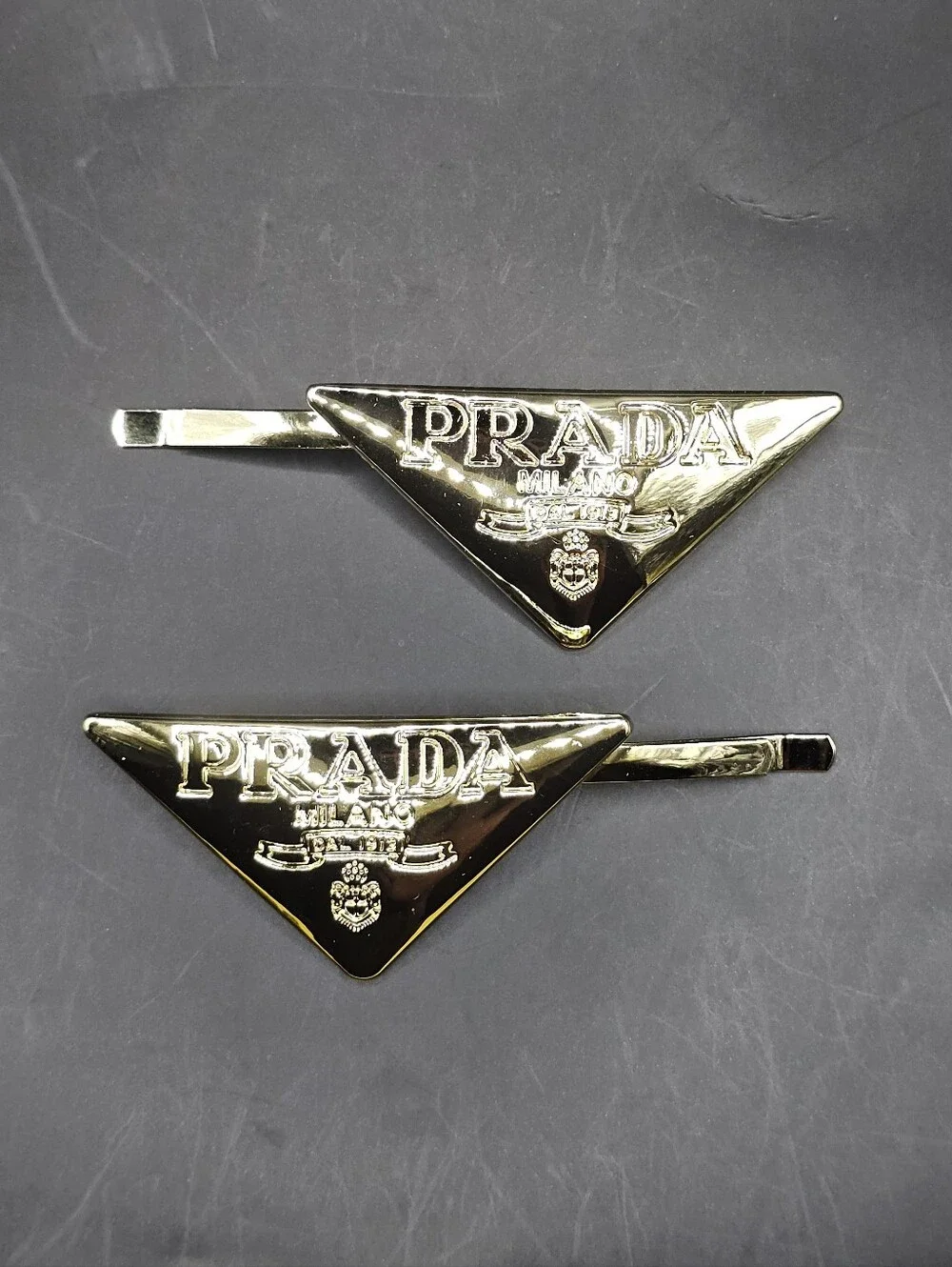 2x Gold Tone Prada Triangle Style Hair Clips